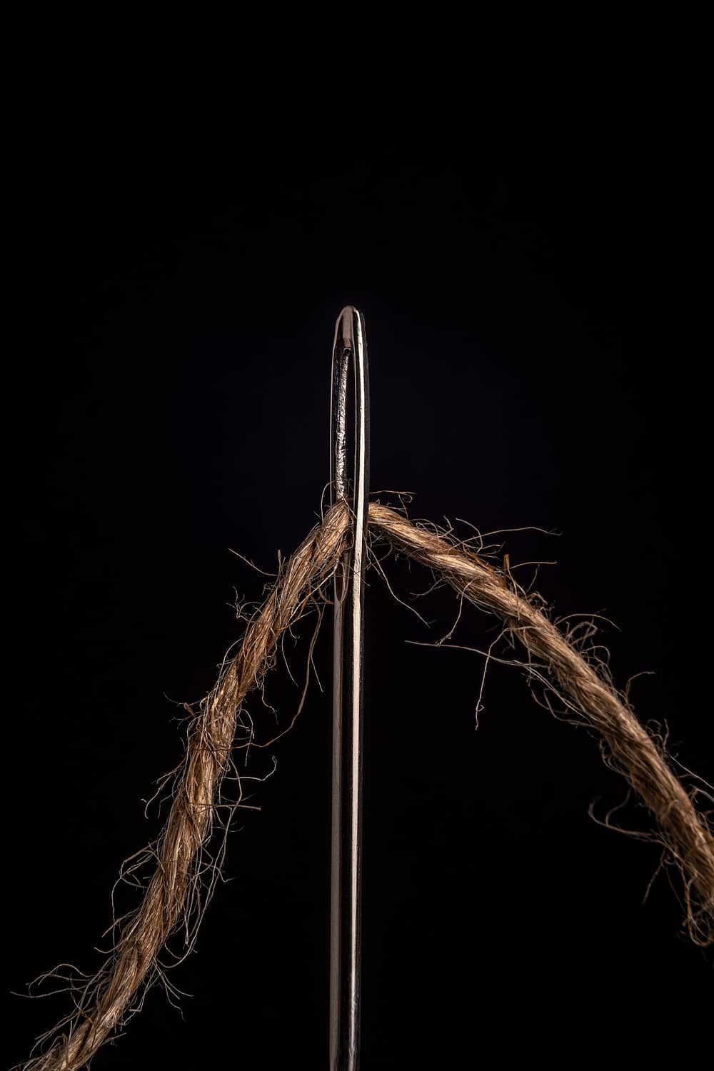 a close up of a needle with thread