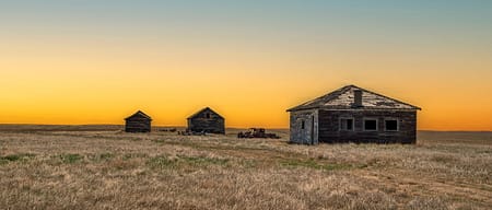 prairie sunset with old home