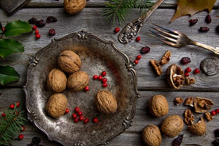 a metal tray with walnuts and foliage