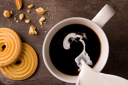 a cup of coffee with cookies