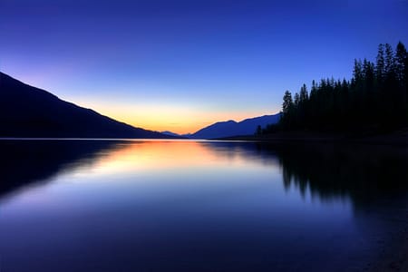 sunset over a body of water with reflections