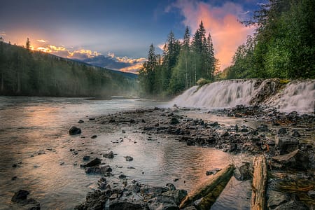 Sunset beaming over a river waterfall