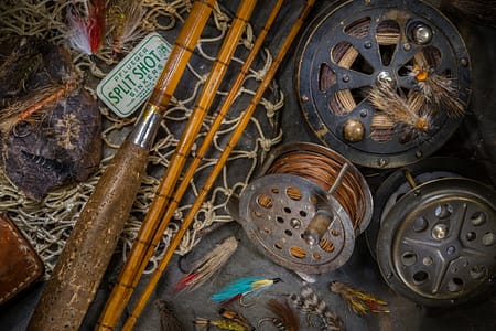 a still life of old fly fishing gear