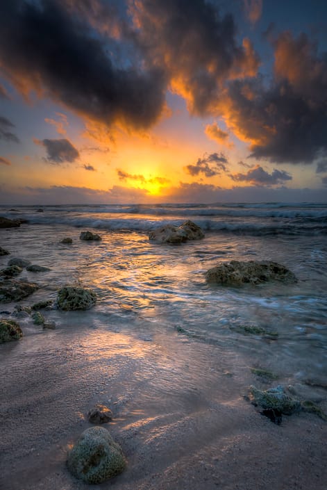 a sunrise over a beach in the Mayan Riviera ocean
