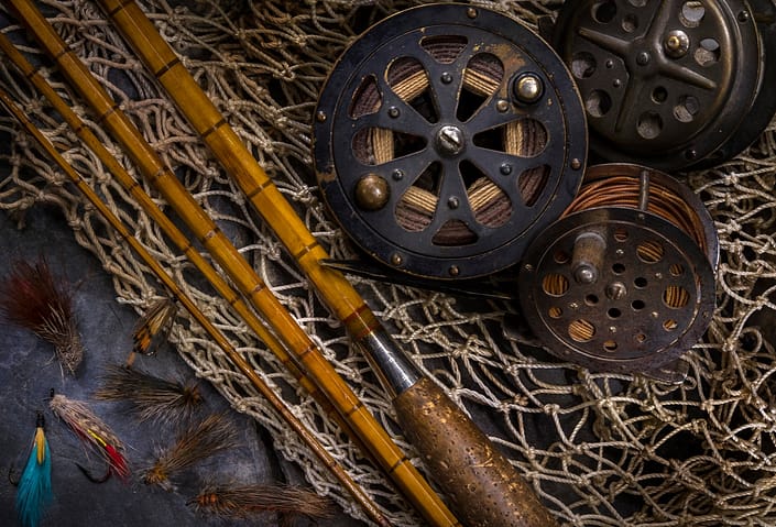 a still life of vintage fly fishing gear