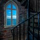 a window in a lighthouse looking over the pacific ocean